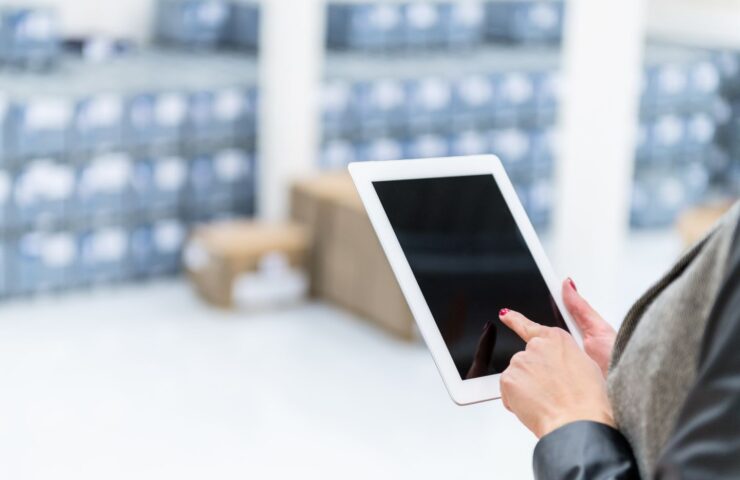 woman pointing to tablet with blue boxes in the background