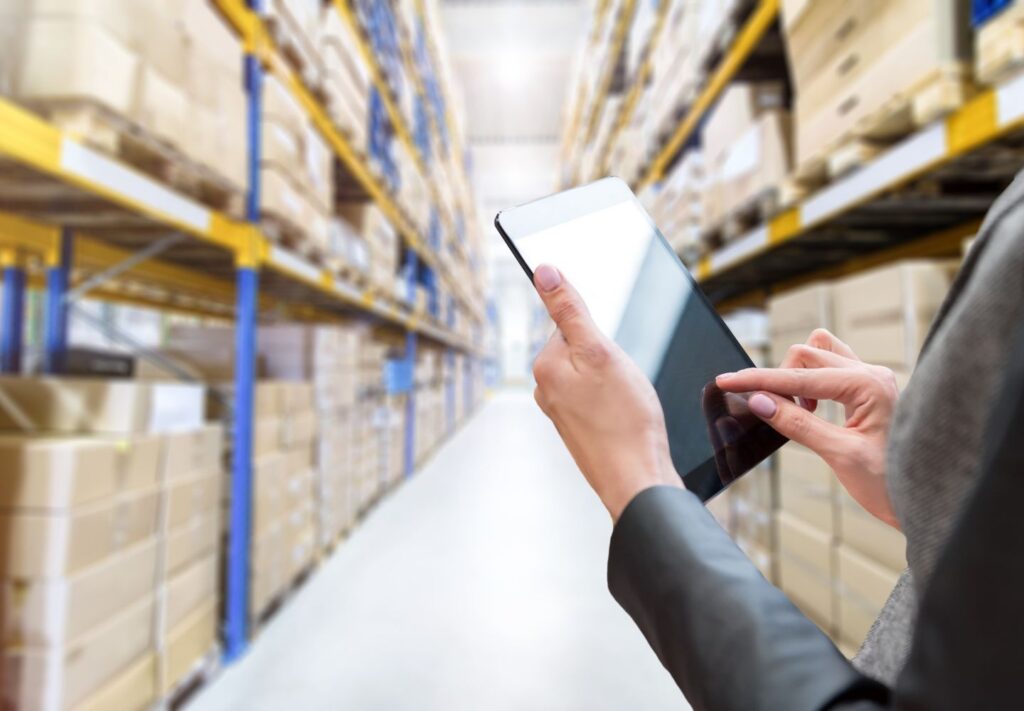 person on tablet in warehouse