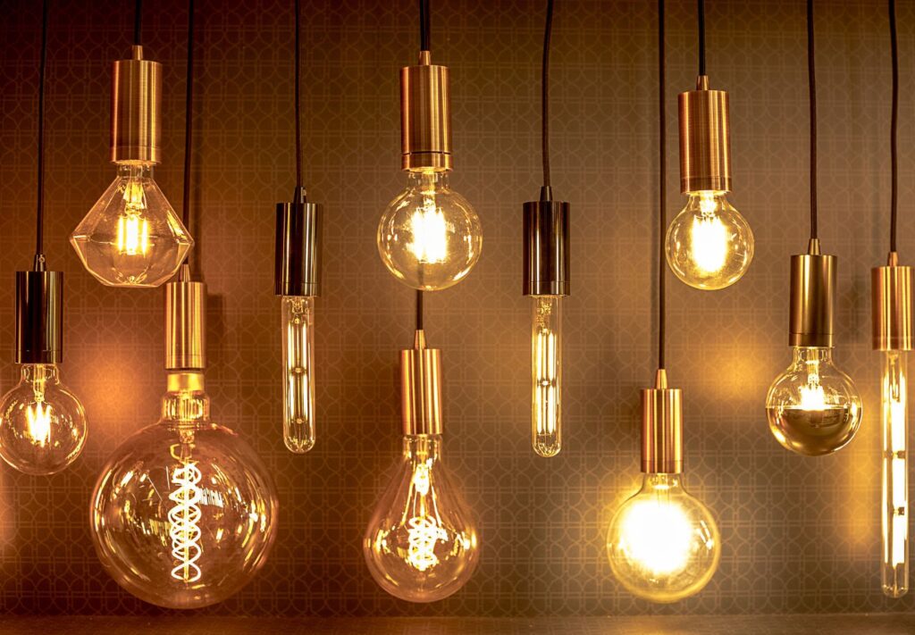 transparent hanging lightbulbs against a dark background
