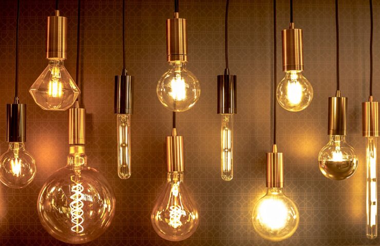 transparent hanging lightbulbs against a dark background